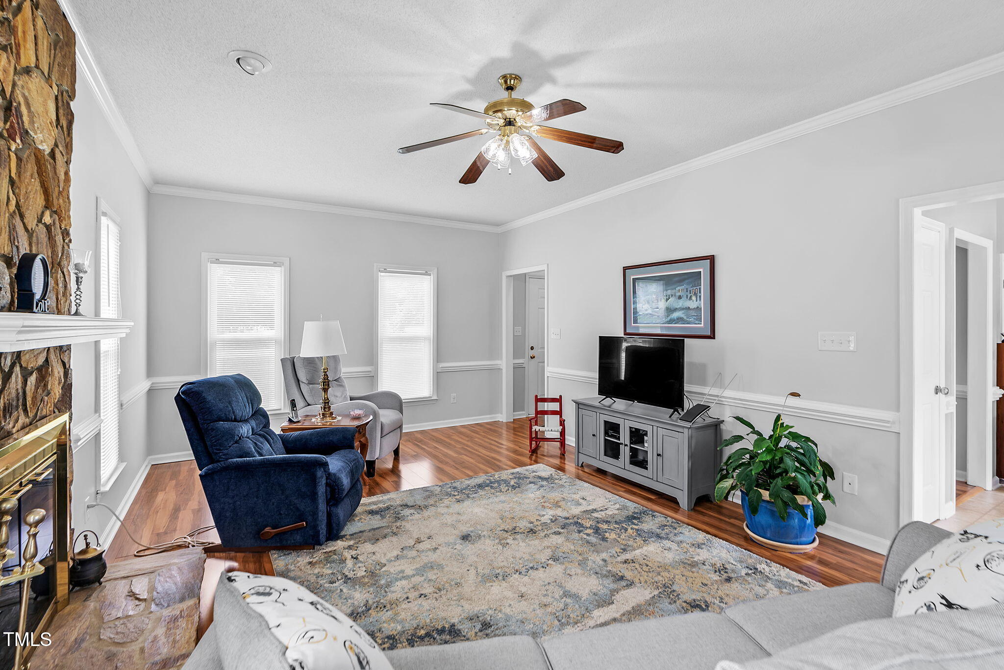 209 Bradley Drive Benson, NC 27504 - Photo 4 of 20 a living room with furniture a fireplace and a flat screen tv