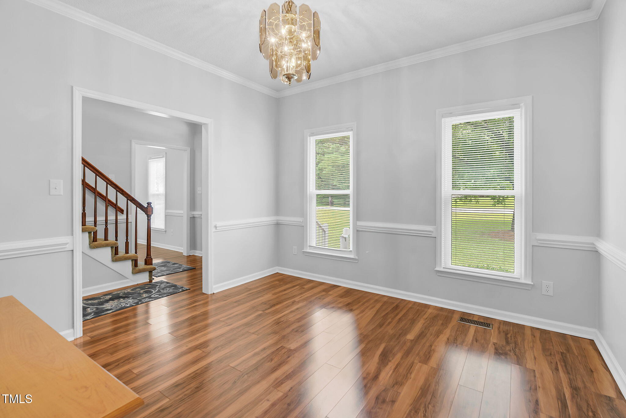 209 Bradley Drive Benson, NC 27504 - Photo 6 of 20 a view of an empty room with wooden floor and a window