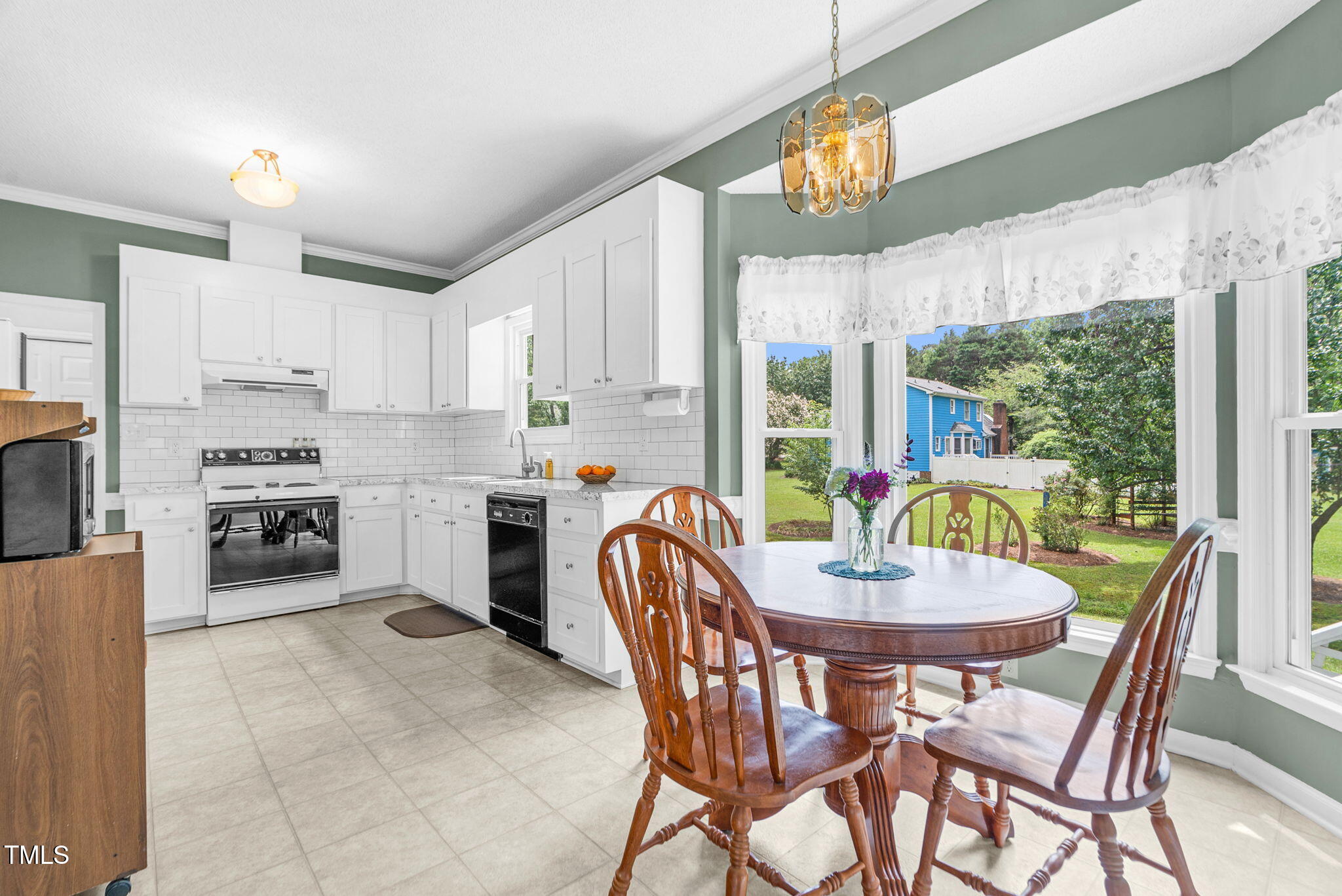 209 Bradley Drive Benson, NC 27504 - Photo 8 of 20 a dining room with furniture a chandelier and kitchen view