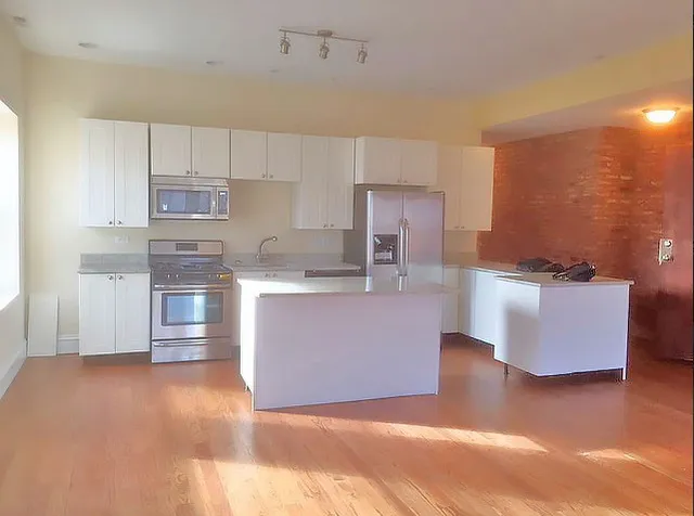 a large kitchen with stainless steel appliances granite countertop a granite counter tops and a cabinets