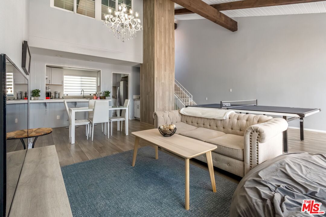 28390 Rey De Copas Lane Malibu, CA 90265 - Photo 1 of 18 a living room with furniture and a chandelier