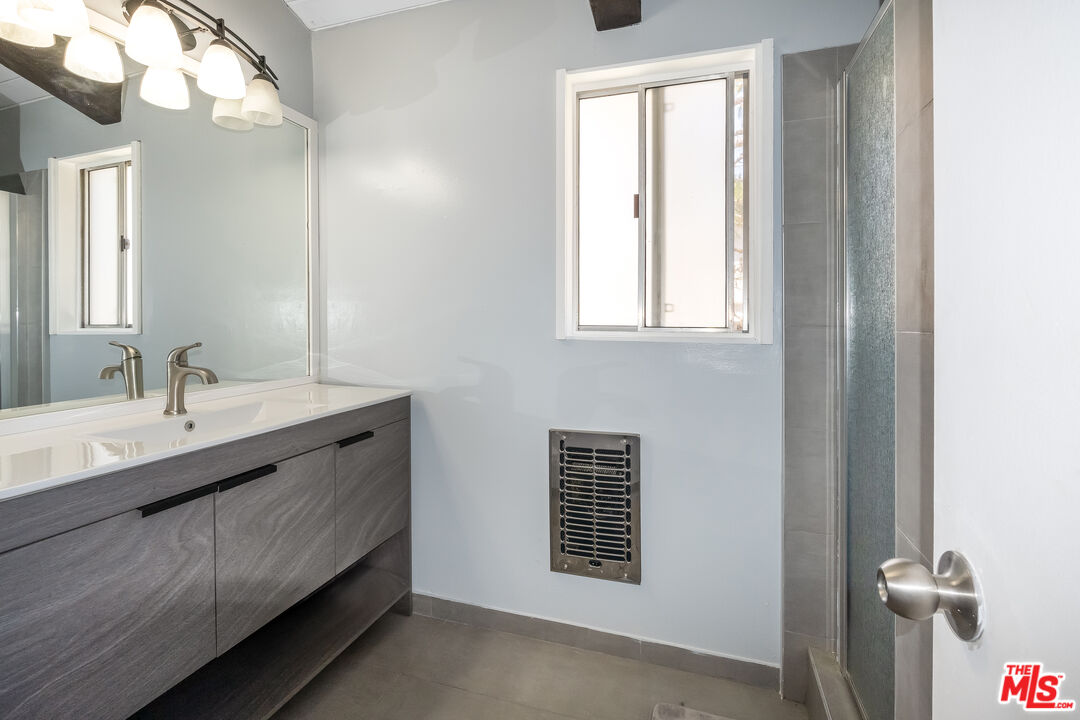 28390 Rey De Copas Lane Malibu, CA 90265 - Photo 12 of 18 a bathroom with a sink a vanity and a mirror