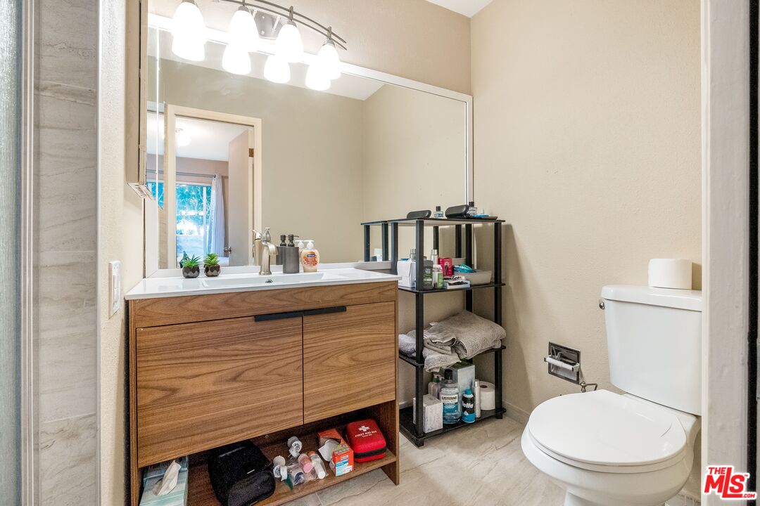 28390 Rey De Copas Lane Malibu, CA 90265 - Photo 15 of 18 a bathroom with a toilet a sink and a mirror