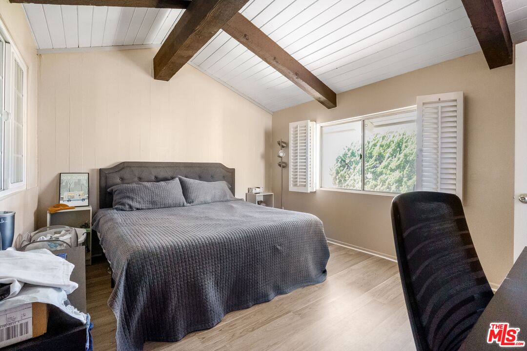 28390 Rey De Copas Lane Malibu, CA 90265 - Photo 6 of 18 a bedroom with a bed and a large window