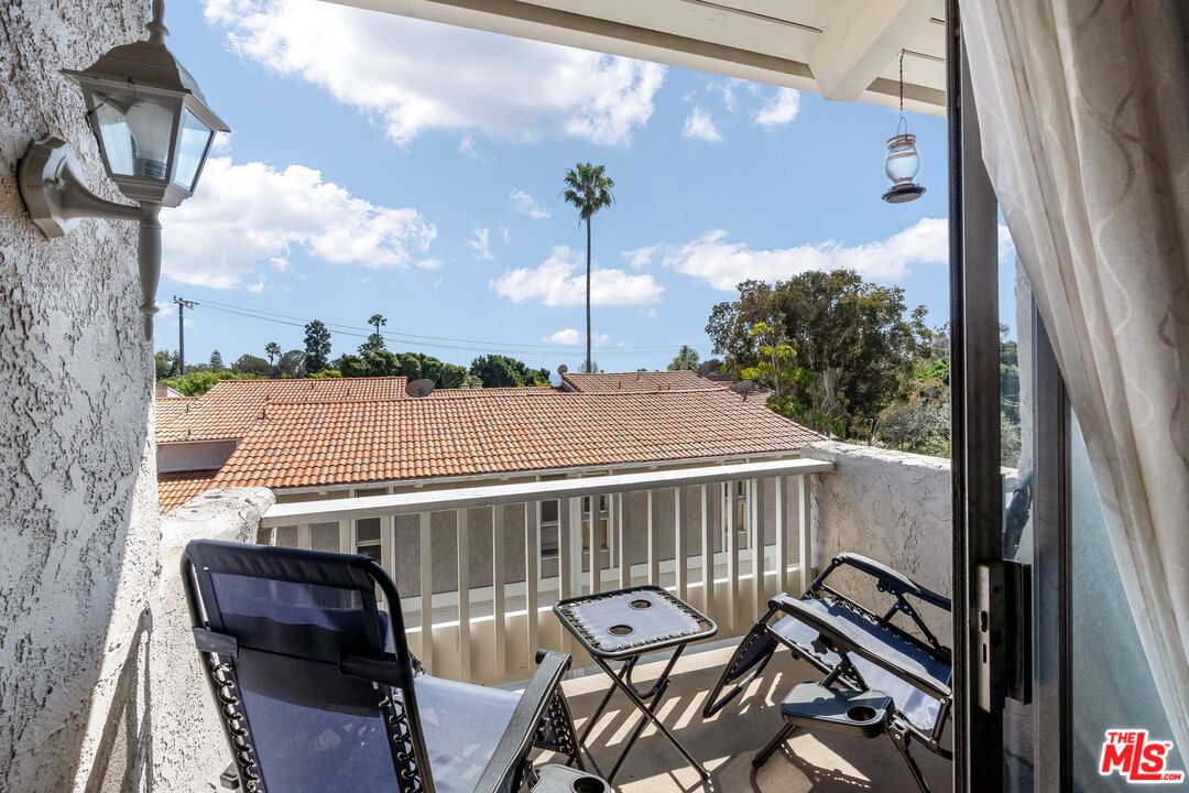 28390 Rey De Copas Lane Malibu, CA 90265 - Photo 8 of 18 a view of a balcony with chairs