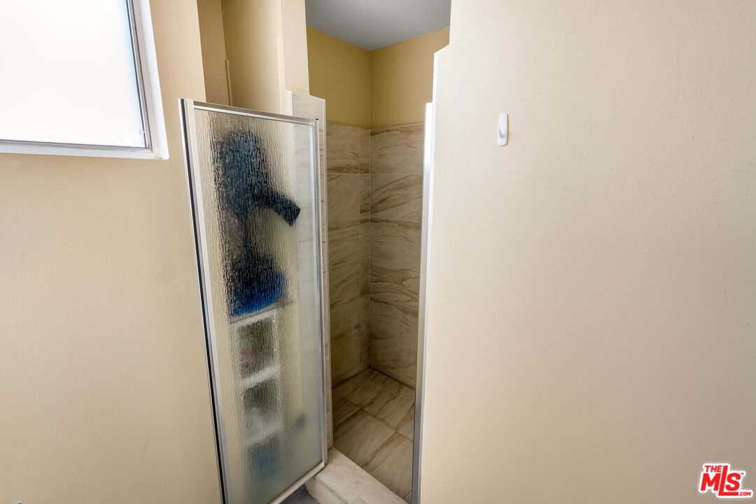 28390 Rey De Copas Lane Malibu, CA 90265 - Photo 10 of 18 a bathroom with a glass shower door