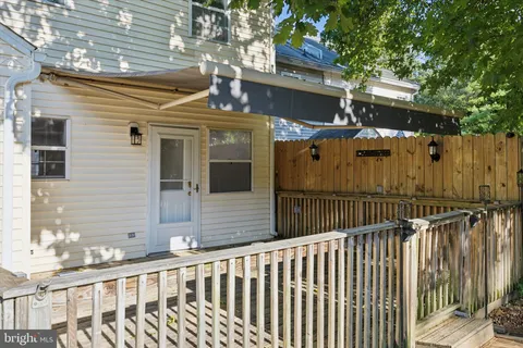 a view of a house with wooden fence