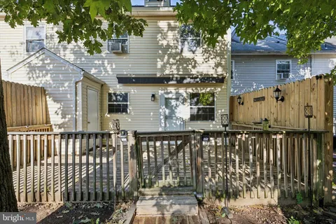 a view of a house with wooden fence