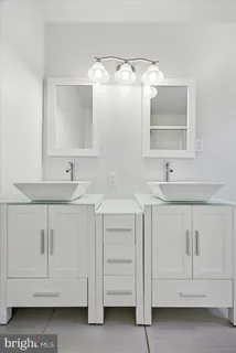 a bathroom with a sink vanity and mirror