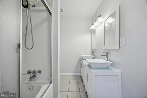 a bathroom with a sink a vanity and shower