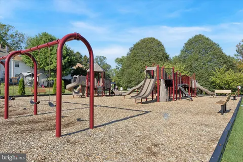 a view of a park with swings and slides