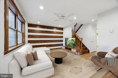 a living room with furniture and a wooden floor