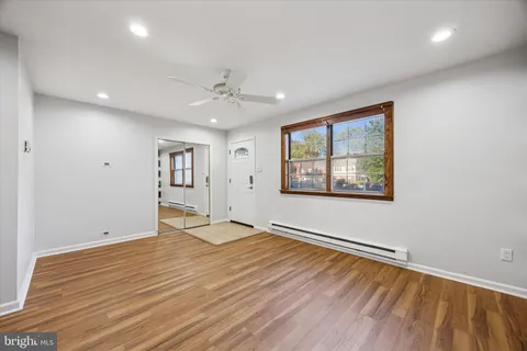 wooden floor in an empty room with a window