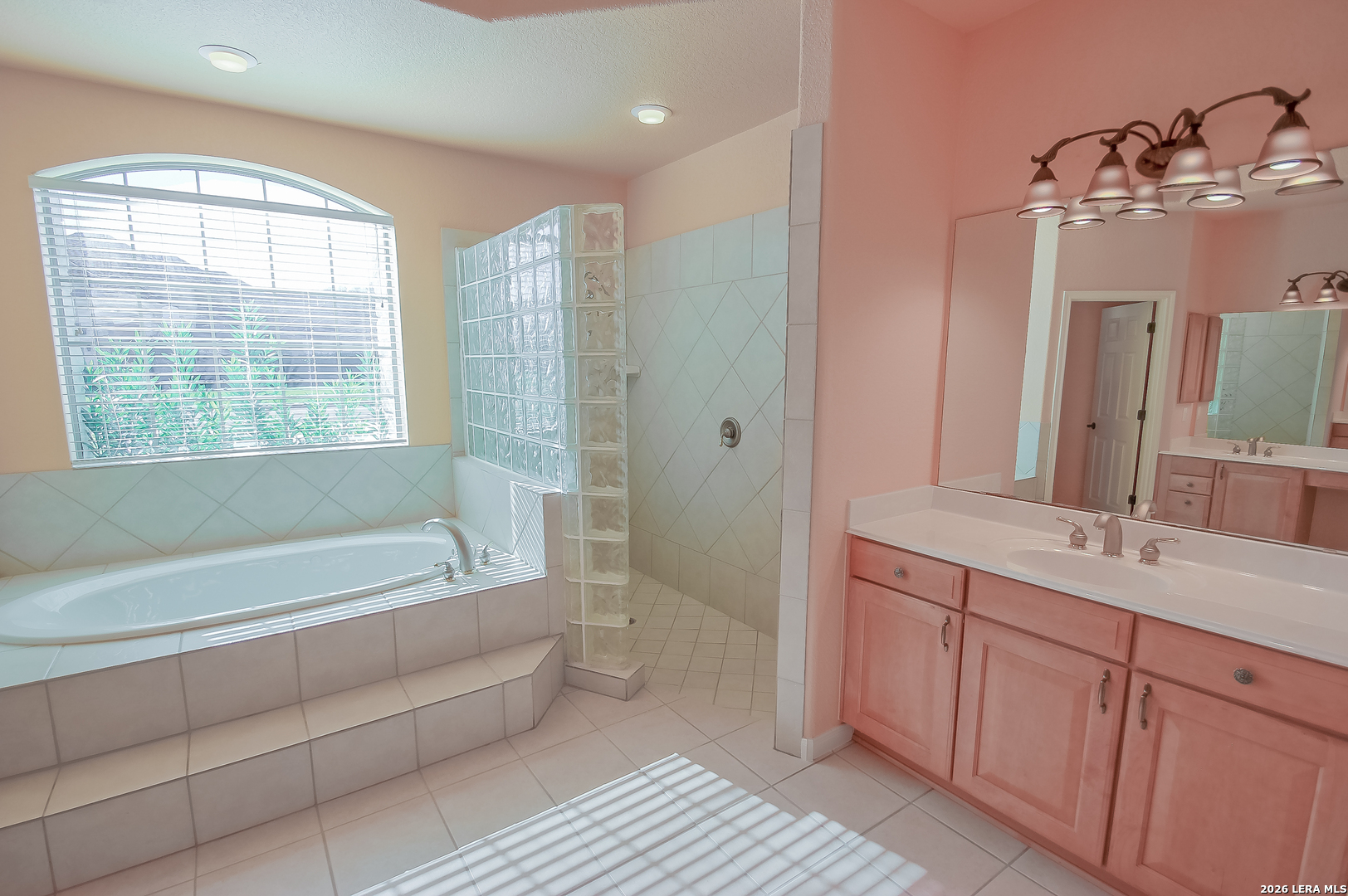 30901 Wood Bine Way Fair Oaks Ranch, TX 78015 - Photo 11 of 23 a bathroom with a tub sink and mirror