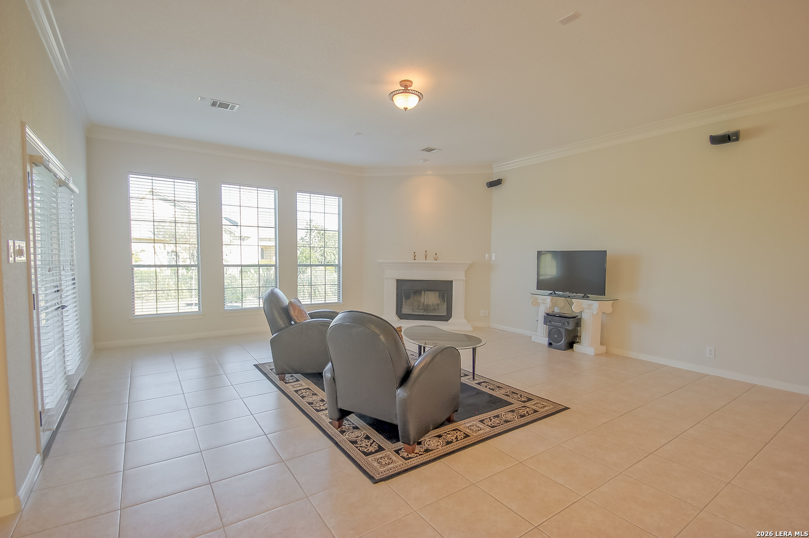 30901 Wood Bine Way Fair Oaks Ranch, TX 78015 - Photo 14 of 23 a living room with furniture a flat screen tv and a large window