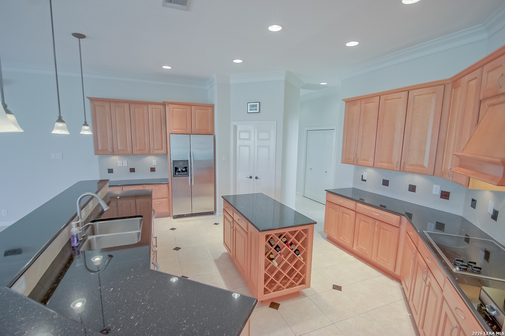 30901 Wood Bine Way Fair Oaks Ranch, TX 78015 - Photo 19 of 23 a kitchen with stainless steel appliances kitchen island granite countertop a sink stove and cabinets