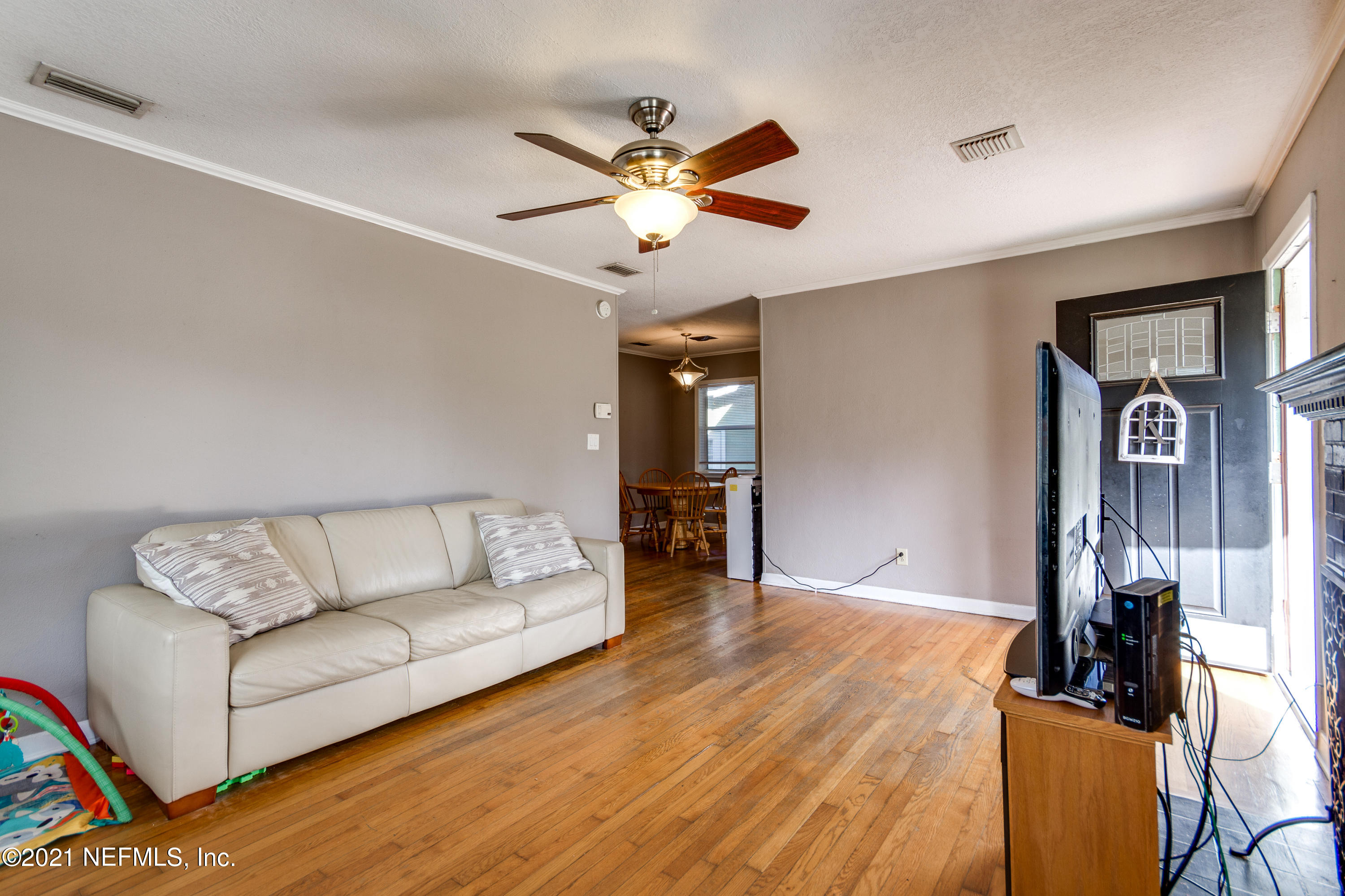 6044 Duke Road Jacksonville, FL 32217 - Photo 7 of 24 a living room with furniture and a chandelier