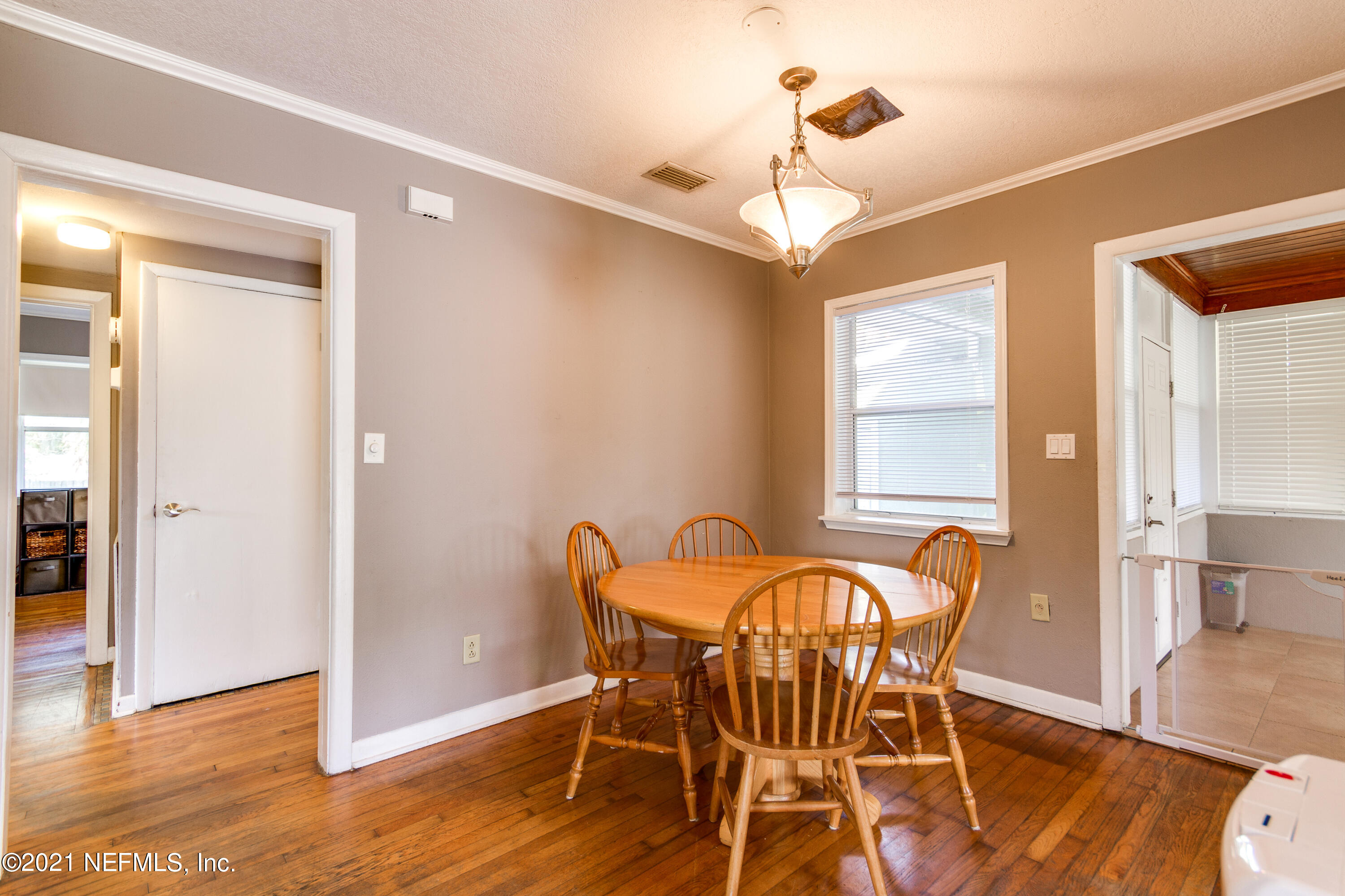 6044 Duke Road Jacksonville, FL 32217 - Photo 8 of 24 a view of a dining room with furniture and wooden floor