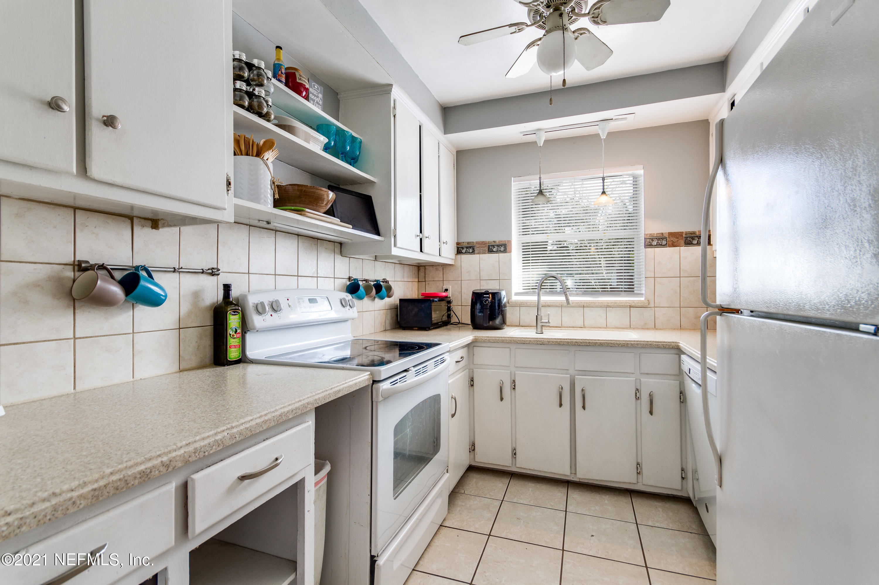 6044 Duke Road Jacksonville, FL 32217 - Photo 10 of 24 a kitchen with a sink cabinets and window