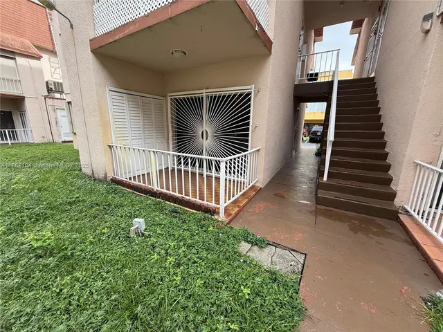 a view of a street with a car parked in front of it