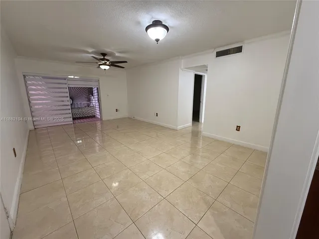 a view of a livingroom with a ceiling fan and window