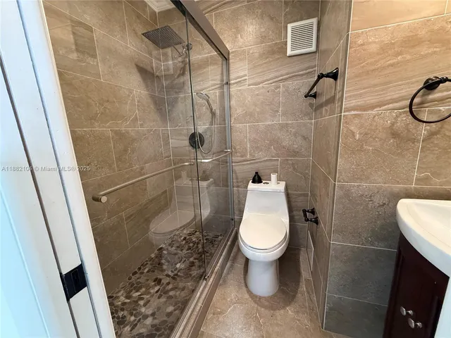a bathroom with a toilet and a shower