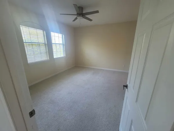 an empty room with a empty space and a ceiling fan
