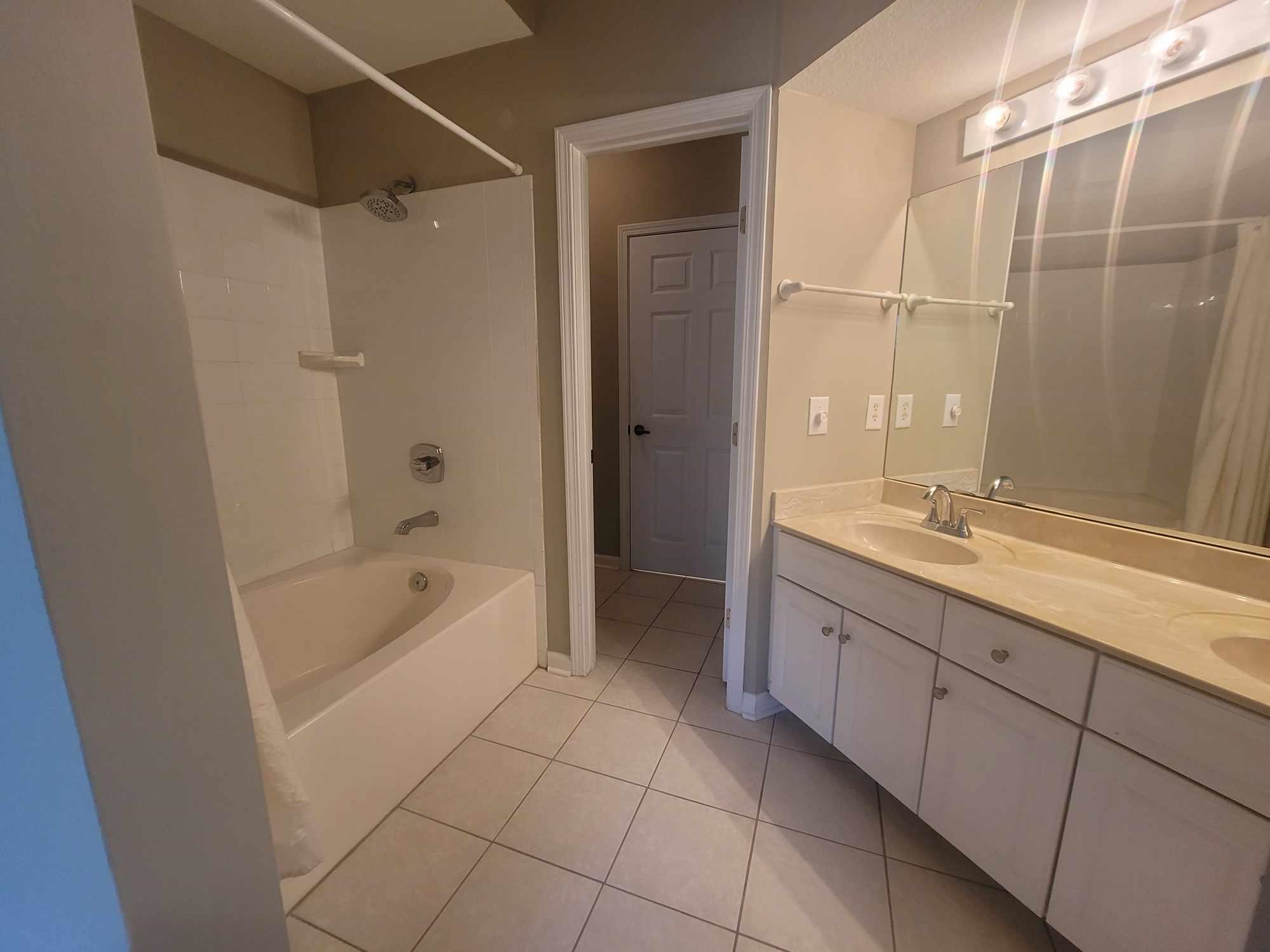 2431 Vista Cove Road St. Augustine, FL 32084 - Photo 16 of 33 a spacious bathroom with a granite countertop sink a mirror and a bathtub