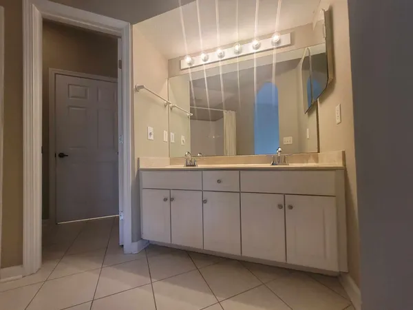 an empty room with a window and a ceiling fan