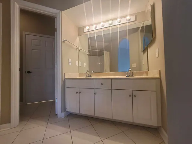 an empty room with a window and a ceiling fan