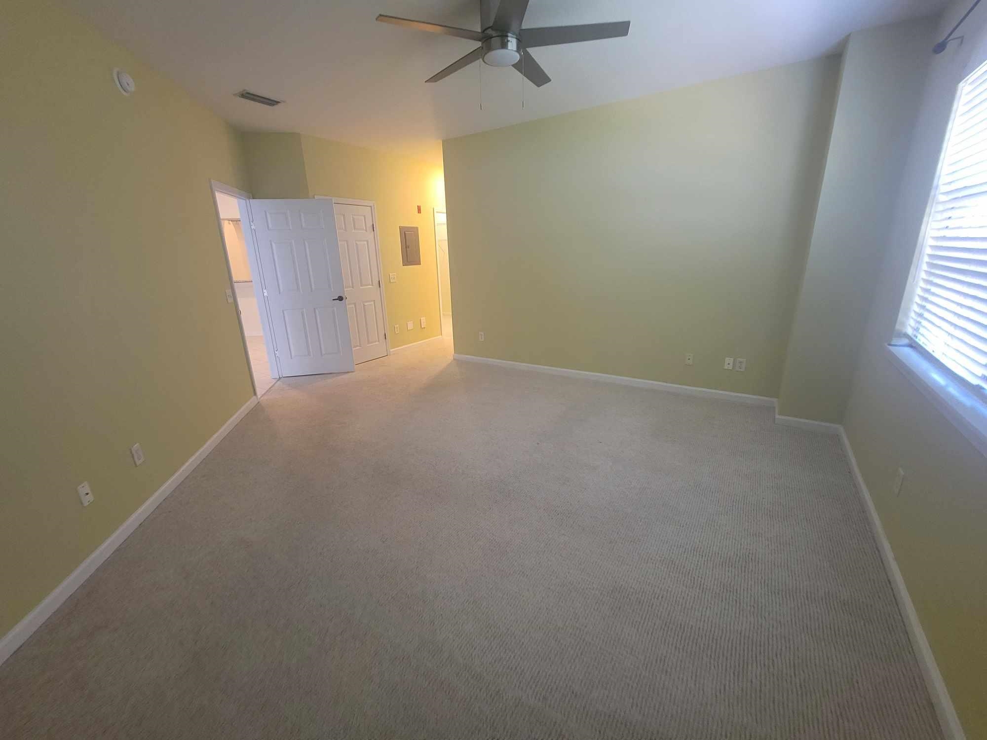 2431 Vista Cove Road St. Augustine, FL 32084 - Photo 18 of 33 an empty room with a window and a ceiling fan