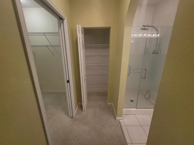 a bathroom with a glass shower door and a sink
