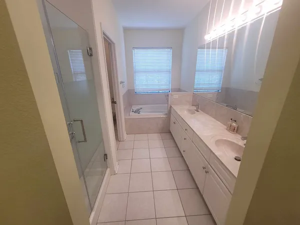 a bath tub sitting in a bathroom next to a window