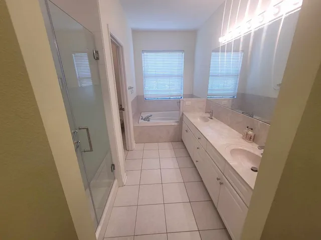 a bath tub sitting in a bathroom next to a window