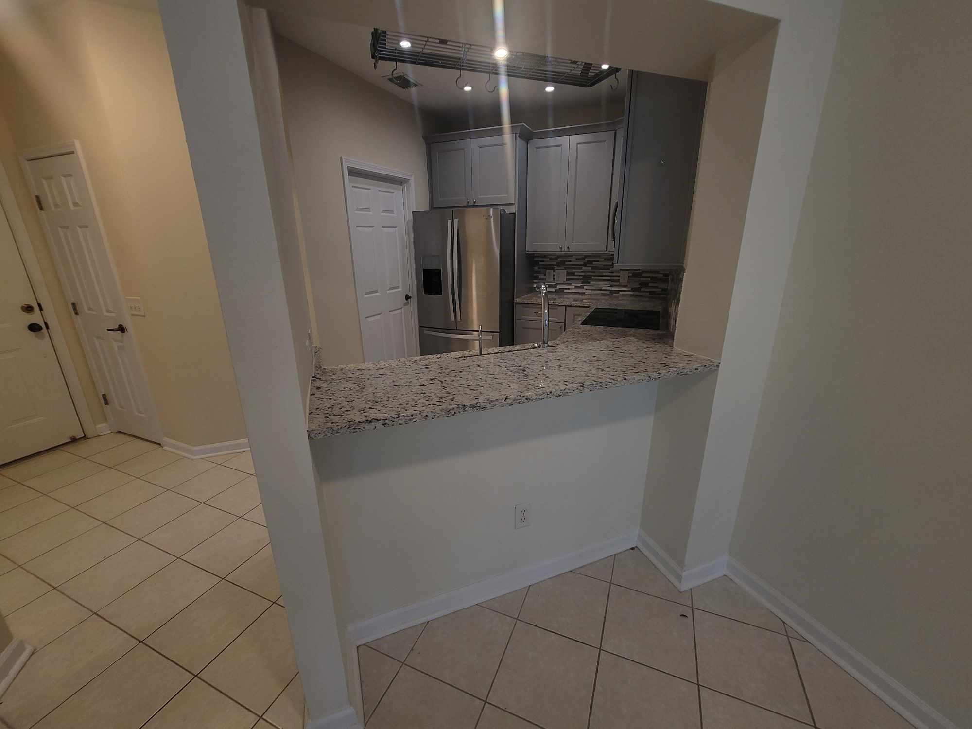 2431 Vista Cove Road St. Augustine, FL 32084 - Photo 6 of 33 a bathroom with a granite countertop sink and a mirror