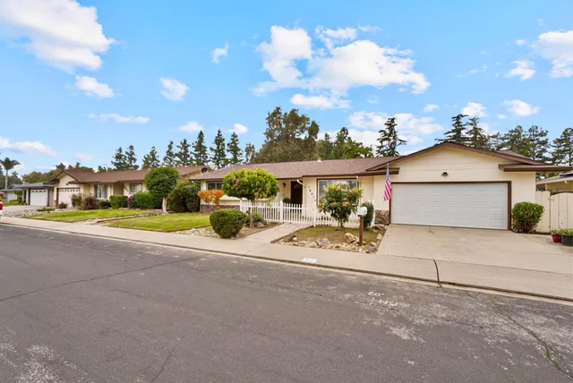 a view of a house with a yard and sitting area
