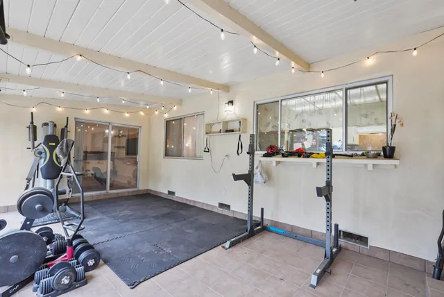 a room with gym equipment and mirror