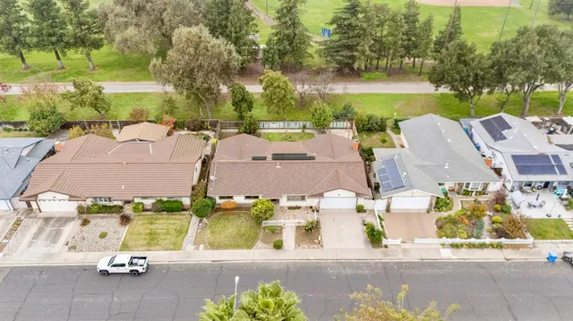an aerial view of residential house with outdoor space and lake view in back