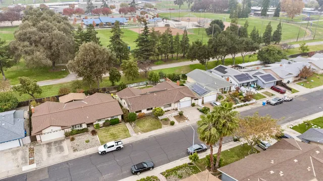 an aerial view of residential house with outdoor space and lake view