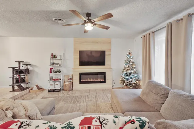 a living room with furniture and a fireplace