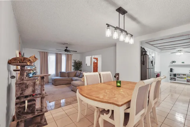 a living room with dining table and chairs