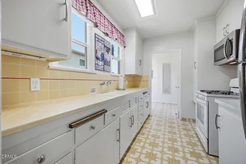 a spacious bathroom with a sink a mirror and a shower