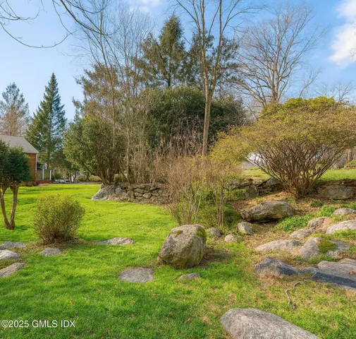 a view of garden with trees and a lake view