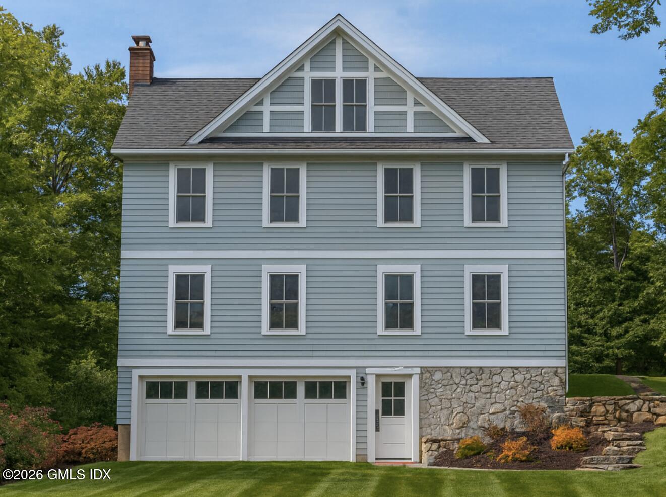 9 Walnut Street Cos Cob, CT 06807 - Photo 5 of 7 a front view of a house with garden