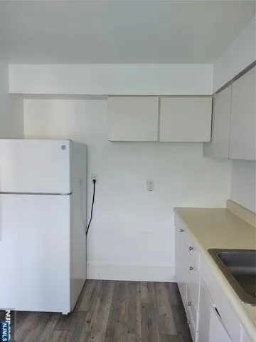 a view of a kitchen with a sink dishwasher and refrigerator