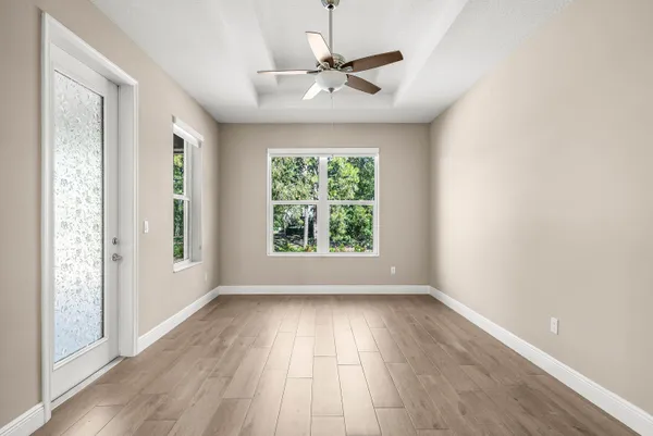 wooden floor in an empty room with a window