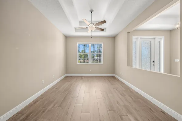 wooden floor in an empty room with a window