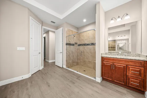 a bathroom with a shower sink and mirror
