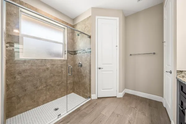 a bathroom with a glass shower door