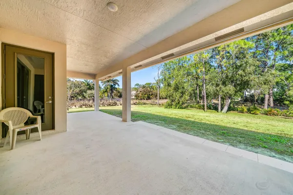 a view of a house with backyard and porch